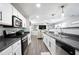 Well-lit kitchen showcases stainless steel appliances, granite countertops, and white cabinets at 2210 Valley Creek Dr, Lithia Springs, GA 30122