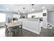 Open-concept kitchen boasts breakfast bar and modern appliances at 2210 Valley Creek Dr, Lithia Springs, GA 30122