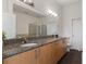 Well-lit bathroom with granite countertop, double sinks, and modern fixtures at 390 17Th Nw St # 6036, Atlanta, GA 30363