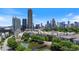 Scenic city view featuring lush greenery, a tranquil pond, and a pedestrian bridge at 390 17Th Nw St # 6036, Atlanta, GA 30363