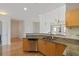 Modern kitchen with granite countertops, stainless steel dishwasher, and bright cabinetry at 390 17Th Nw St # 6036, Atlanta, GA 30363