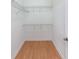Empty walk-in closet featuring laminate floors and wire shelving at 390 17Th Nw St # 6036, Atlanta, GA 30363