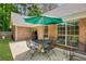 Spacious backyard featuring a patio with seating and a large green umbrella at 5850 Shannon Dr, Cumming, GA 30040