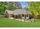 Large and well-maintained backyard featuring a patio, outdoor seating, and green lawn space at 5850 Shannon Dr, Cumming, GA 30040