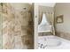 Beautiful bathroom features tile shower, jacuzzi tub, and a window with natural light at 5850 Shannon Dr, Cumming, GA 30040