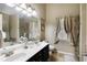 Bathroom with double sink vanity, tile floors, and separate tub and shower at 5850 Shannon Dr, Cumming, GA 30040