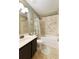 Tiled bathroom featuring a tub/shower combo and vanity at 5850 Shannon Dr, Cumming, GA 30040