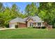 Charming brick home featuring a manicured lawn, two-car garage and a beautifully landscaped front yard at 5850 Shannon Dr, Cumming, GA 30040