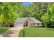 Charming brick home featuring a manicured lawn, two-car garage and a beautifully landscaped front yard at 5850 Shannon Dr, Cumming, GA 30040