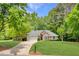 Charming brick home featuring a manicured lawn, two-car garage and a beautifully landscaped front yard at 5850 Shannon Dr, Cumming, GA 30040