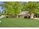 Well-maintained lawn and mature trees frame this charming brick home with a fenced-in yard at 5850 Shannon Dr, Cumming, GA 30040
