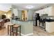 Cozy kitchen features granite countertops, stainless steel appliances, and bar seating at 5850 Shannon Dr, Cumming, GA 30040