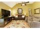 Inviting living room with vaulted ceiling, laminate flooring, and comfortable brown leather seating at 5850 Shannon Dr, Cumming, GA 30040
