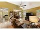 Bright living room with vaulted ceiling, hardwood floors, and access to kitchen and dining area at 5850 Shannon Dr, Cumming, GA 30040