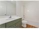 Bathroom with shower and tub combination, sleek sink with white countertop, and green cabinets at 84 Conner Glenn Dr, Hiram, GA 30141