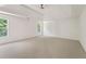 Spacious bedroom featuring a tray ceiling, ceiling fan, and two windows at 84 Conner Glenn Dr, Hiram, GA 30141