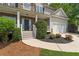 Charming home exterior showcasing stone accents, landscaped yard, and a two-car garage at 84 Conner Glenn Dr, Hiram, GA 30141