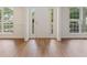 Bright foyer features wood floors, a white front door, and windows on either side at 84 Conner Glenn Dr, Hiram, GA 30141