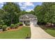 Beautiful two-story home with manicured lawn, mature trees, and a welcoming front porch at 84 Conner Glenn Dr, Hiram, GA 30141