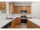Modern kitchen features stainless steel appliances, quartz countertops, and wood cabinetry at 84 Conner Glenn Dr, Hiram, GA 30141