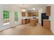 Eat-in kitchen with stainless appliances, wood cabinets, center island, and door to the deck at 84 Conner Glenn Dr, Hiram, GA 30141