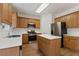 Well-equipped kitchen with stainless appliances, a center island, wood cabinets, and laminate floors at 84 Conner Glenn Dr, Hiram, GA 30141