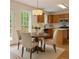 Eat-in kitchen with wood cabinets, stainless appliances, breakfast table, and backyard access at 84 Conner Glenn Dr, Hiram, GA 30141