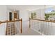 Well-lit landing area with carpet flooring, decorative lighting, and staircase at 84 Conner Glenn Dr, Hiram, GA 30141