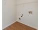 This laundry room with wood floor features water and gas hookups and a wire shelf at 84 Conner Glenn Dr, Hiram, GA 30141