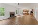 Spacious living room featuring a stone fireplace, wood floors, and an open layout with a ceiling fan at 84 Conner Glenn Dr, Hiram, GA 30141