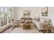 Cozy living room with neutral furniture, light walls, wood floors, and natural light from large windows at 84 Conner Glenn Dr, Hiram, GA 30141