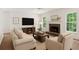 Inviting living room with stone fireplace, mounted TV, and plush neutral furniture at 84 Conner Glenn Dr, Hiram, GA 30141