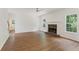 Bright and spacious living room featuring hardwood floors, a ceiling fan, and stone fireplace at 84 Conner Glenn Dr, Hiram, GA 30141
