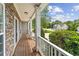 Covered porch with stone accents, white columns, and well-maintained landscaping at 84 Conner Glenn Dr, Hiram, GA 30141