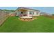 Spacious backyard features a covered patio, well-maintained lawn and a sculpture at 1061 Towne Mill Xing, Canton, GA 30114