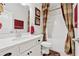 Neat bathroom features a vanity with a single sink and a shower with a brown patterned curtain at 1061 Towne Mill Xing, Canton, GA 30114