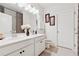 Bright bathroom featuring double sink vanity, white cabinets, and matching neutral walls at 1061 Towne Mill Xing, Canton, GA 30114
