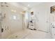 Bright bathroom featuring a glass-enclosed shower and white shelving for towels at 1061 Towne Mill Xing, Canton, GA 30114