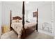 Bedroom featuring a four-poster bed, soft carpet, and neutral color scheme at 1061 Towne Mill Xing, Canton, GA 30114