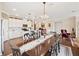 Dining area with an elegant chandelier, and an open view of the modern kitchen at 1061 Towne Mill Xing, Canton, GA 30114