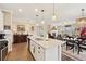 Open-concept kitchen featuring an island with a double sink, granite countertops, and stainless appliances at 1061 Towne Mill Xing, Canton, GA 30114