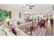 Open-concept living room with view of kitchen, includes sofas, ceiling fan, and area rug at 1061 Towne Mill Xing, Canton, GA 30114