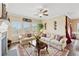Cozy living room featuring plush seating, ceiling fan, large windows and an elegant area rug at 1061 Towne Mill Xing, Canton, GA 30114