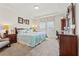 Well-lit main bedroom with neutral carpet, tray ceiling, and traditional furniture at 1061 Towne Mill Xing, Canton, GA 30114