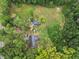 Aerial view reveals a residence and outbuilding on a verdant lot, offering space and seclusion at 1646 Highway 92 N, Fayetteville, GA 30214