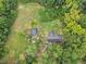 A high angle of the property showcasing the home and outbuilding nestled in a lush environment at 1646 Highway 92 N, Fayetteville, GA 30214