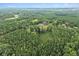 Scenic aerial view of property nestled within a dense forest, promising a tranquil and private living experience at 1646 Highway 92 N, Fayetteville, GA 30214