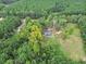 A bird's eye view of a property set amidst lush greenery, offering a secluded and calming environment at 1646 Highway 92 N, Fayetteville, GA 30214