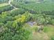 Expansive aerial view of property surrounded by lush green trees, a serene setting with a long driveway at 1646 Highway 92 N, Fayetteville, GA 30214