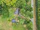 Aerial view of the property featuring a home, outbuilding, and sprawling green lawn, perfect for outdoor activities at 1646 Highway 92 N, Fayetteville, GA 30214